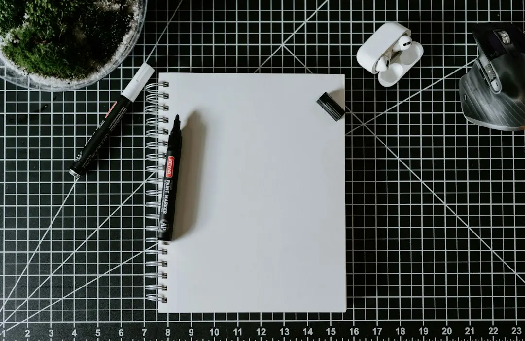 A person comparing notes on a notepad at a desk before choosing an IPTV service such as AlwaysTivi